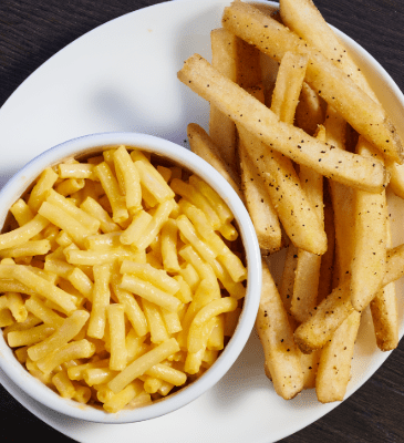 a bowl of Mac and cheese and French fries
